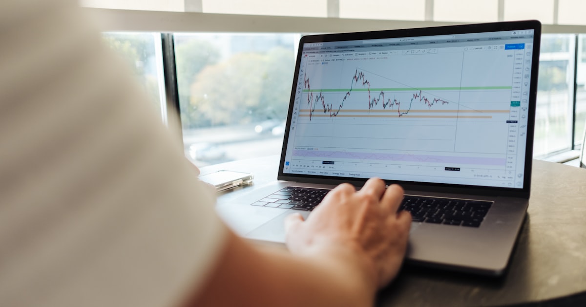 Business professional analyzing revenue growth charts on a laptop